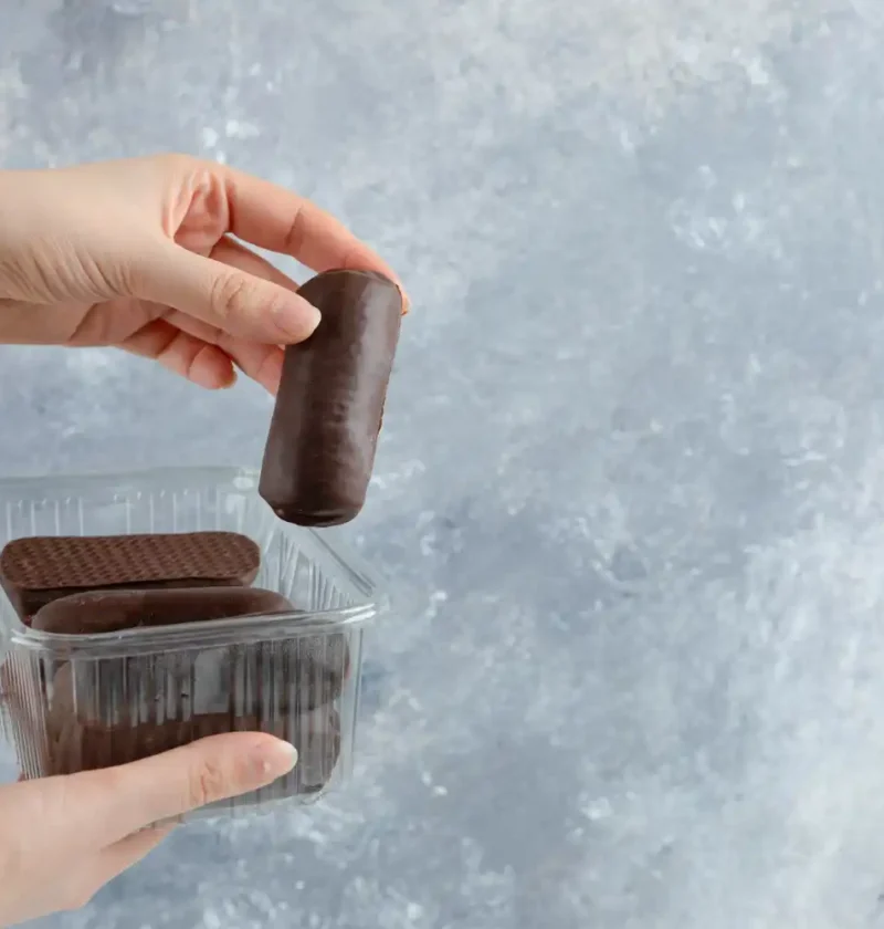 Embalagem blister de chocolate sendo aberta, destacando a diferenciação no ponto de venda para impulsionar o sucesso nas vendas online.